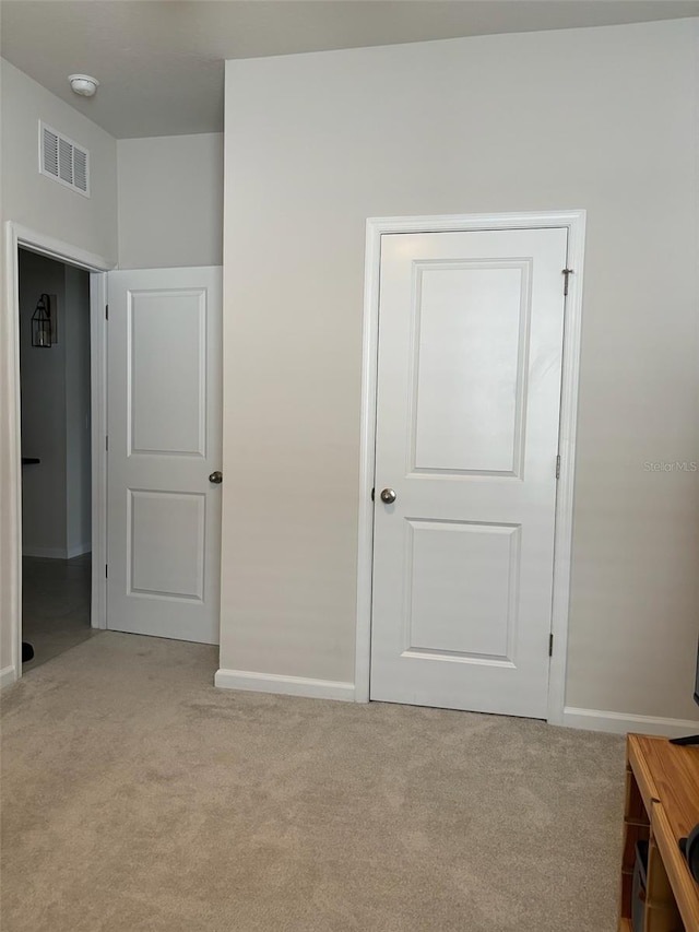 unfurnished bedroom with light carpet