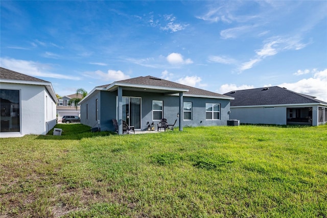 back of property with a yard and cooling unit