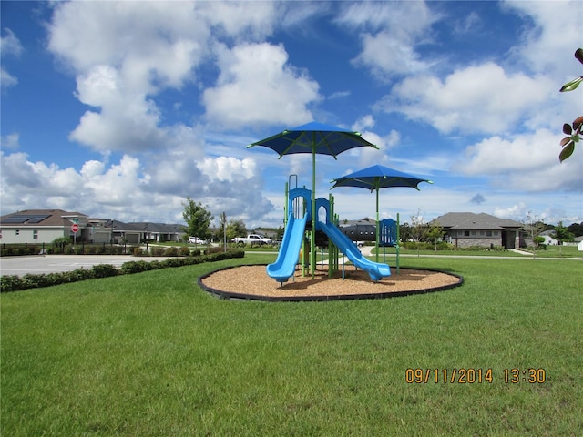 view of playground with a lawn