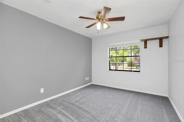 unfurnished room featuring ceiling fan and carpet