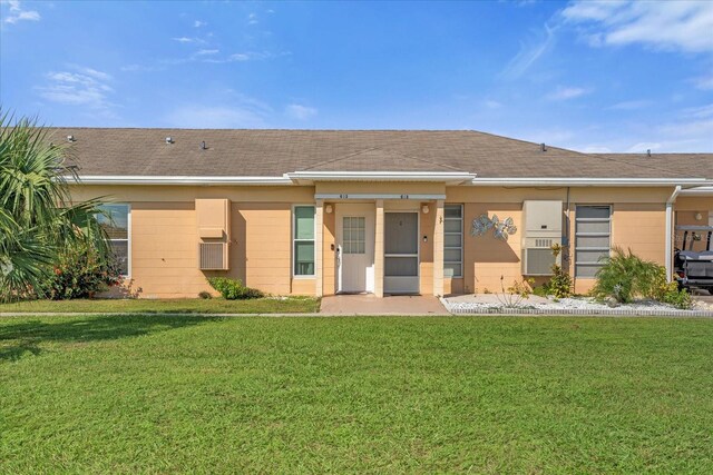 back of property featuring a lawn