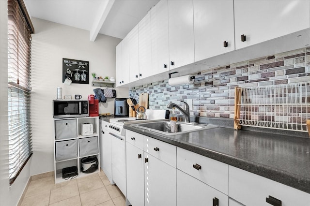 kitchen with sink, beam ceiling, white cabinetry, backsplash, and light tile patterned floors