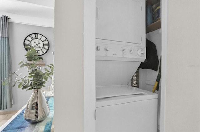 laundry area with stacked washer and dryer