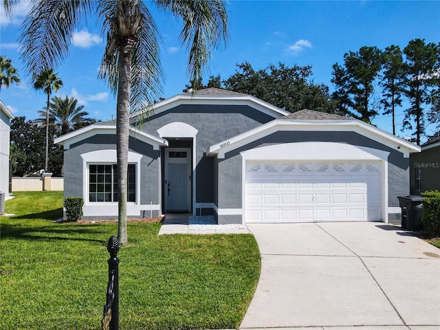 view of front of home with a front yard and a garage