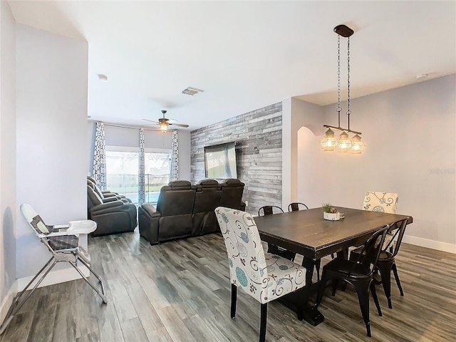 dining area with hardwood / wood-style floors and ceiling fan