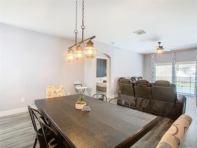 dining space with dark hardwood / wood-style flooring and ceiling fan