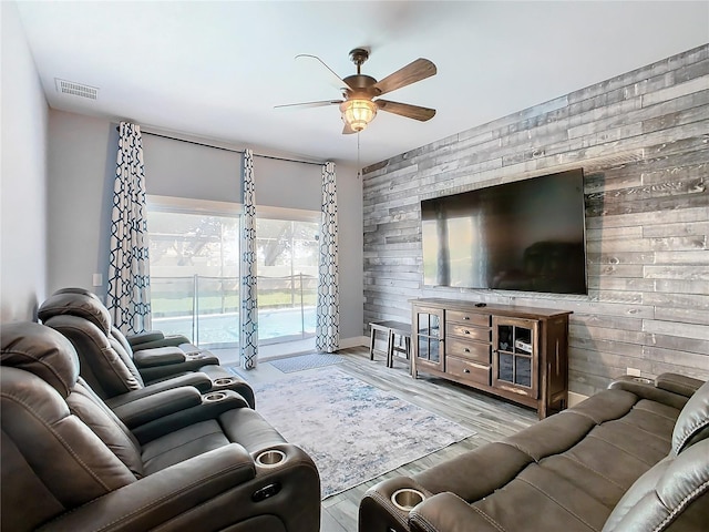 living room with ceiling fan and light hardwood / wood-style flooring