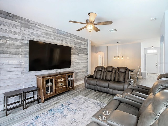 living room with light wood-type flooring and ceiling fan