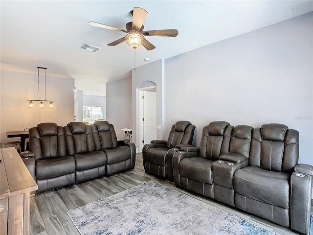 living room with light hardwood / wood-style floors and ceiling fan