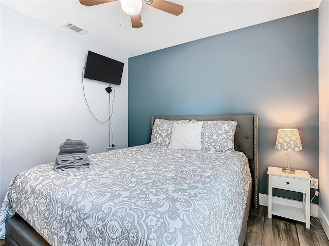 bedroom featuring ceiling fan and dark hardwood / wood-style floors