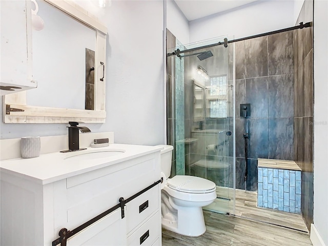 bathroom featuring walk in shower, vanity, toilet, and wood-type flooring