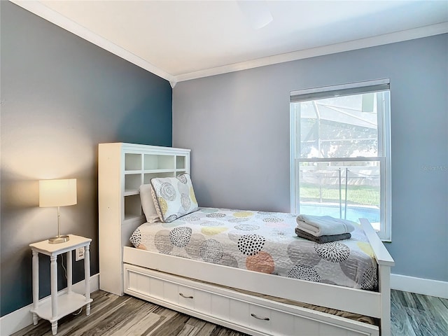 bedroom featuring hardwood / wood-style flooring and crown molding