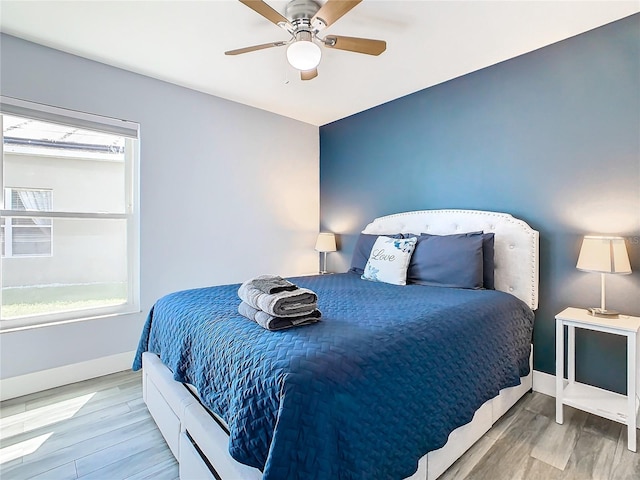 bedroom with light wood-type flooring and ceiling fan