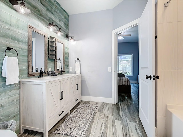 bathroom with ceiling fan, vanity, and hardwood / wood-style flooring