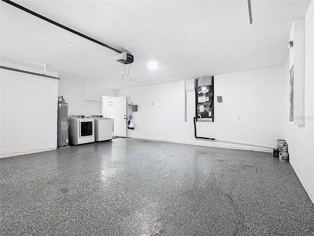 garage with heating unit, a garage door opener, electric water heater, and washer and clothes dryer