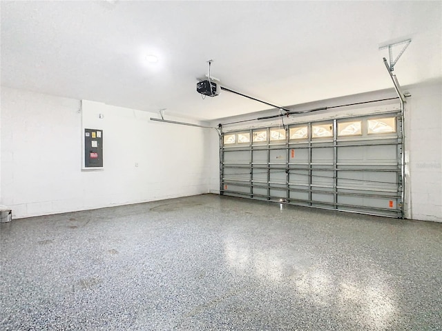 garage with a garage door opener and electric panel