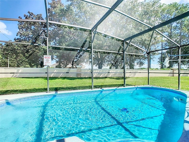 view of pool featuring a yard and glass enclosure