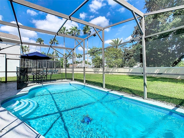 view of swimming pool featuring a lawn, a lanai, and a patio area