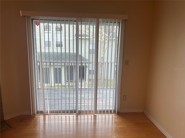 unfurnished room with wood-type flooring