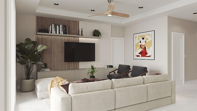 living room with a tray ceiling and ceiling fan