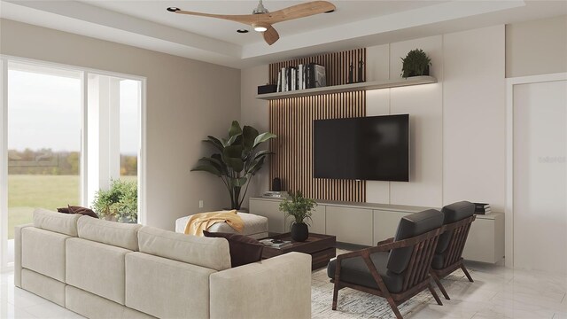 living room featuring a raised ceiling and ceiling fan