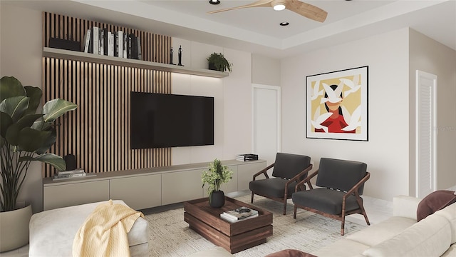 living room with ceiling fan and a raised ceiling