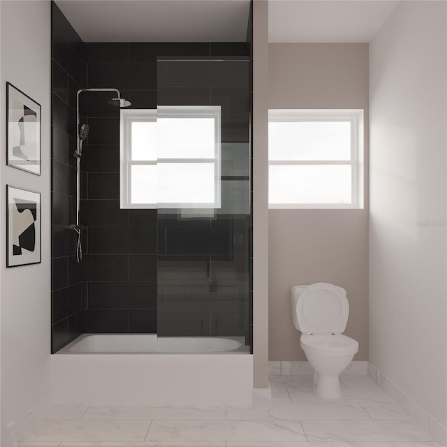 bathroom with tiled shower / bath combo and toilet