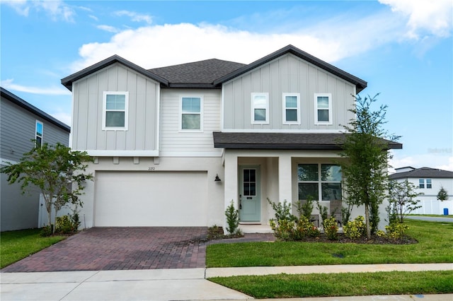 view of front facade with a front yard and a garage