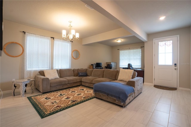 tiled living room featuring an inviting chandelier and a healthy amount of sunlight