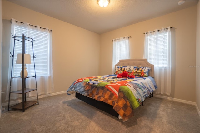 carpeted bedroom with a textured ceiling