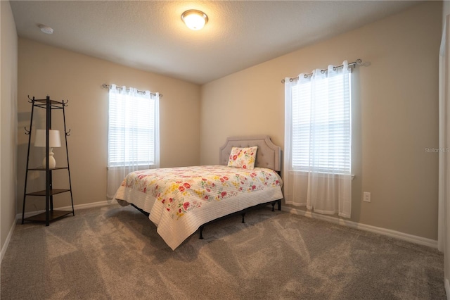 carpeted bedroom featuring a textured ceiling