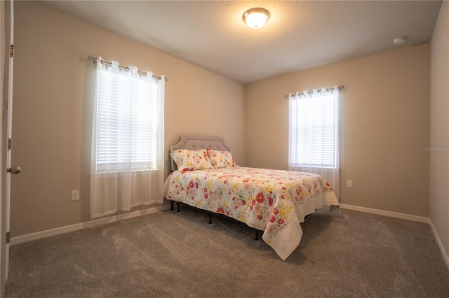 carpeted bedroom with a textured ceiling