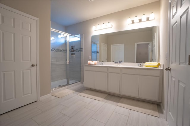 bathroom with walk in shower and vanity