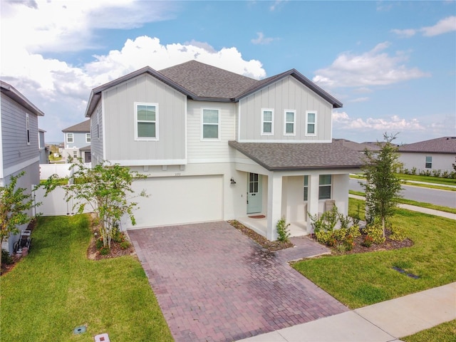 view of front of property featuring a garage and a front yard