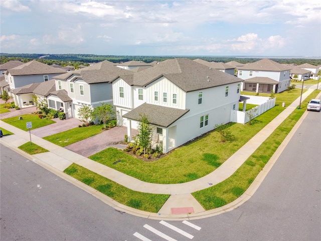 view of front of property with a garage and a front lawn