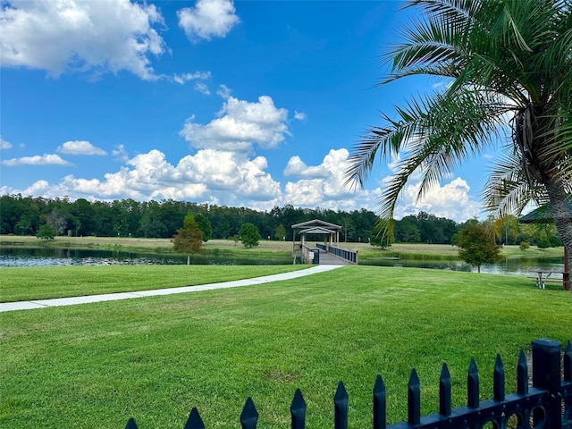 view of community featuring a yard and a water view