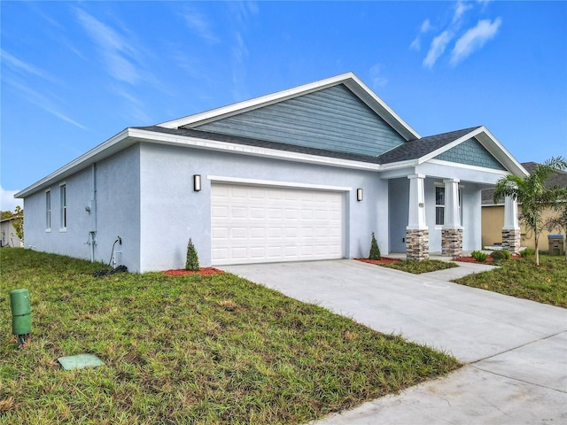 view of front of home featuring a front yard and a garage