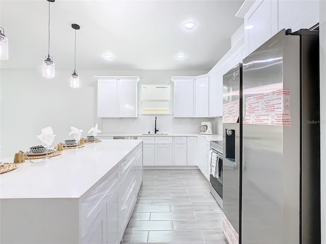 kitchen with sink, white cabinets, and stainless steel appliances