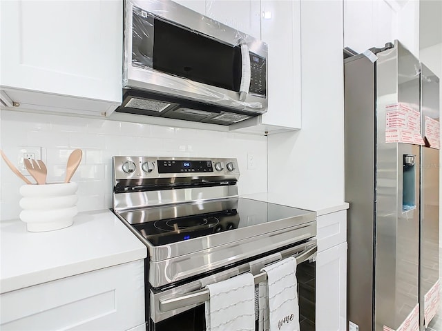 kitchen featuring appliances with stainless steel finishes and white cabinets