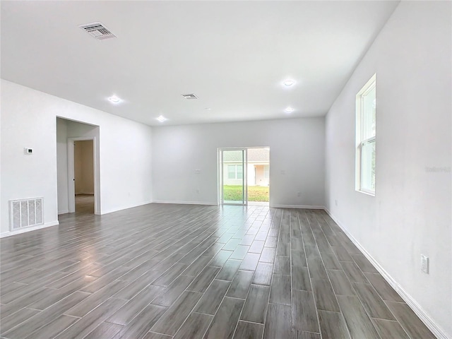 unfurnished room with dark hardwood / wood-style floors