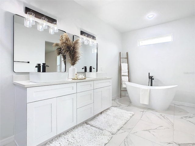 bathroom featuring vanity and a tub