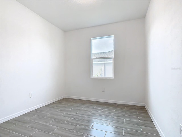 unfurnished room with wood-type flooring