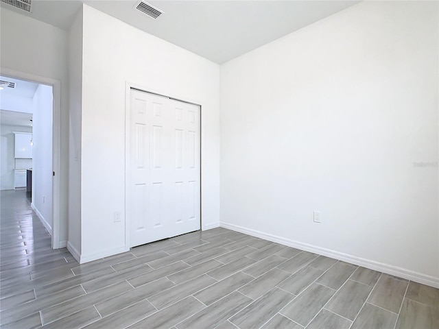 unfurnished bedroom featuring a closet and light wood-type flooring