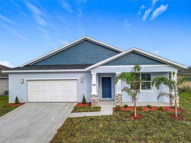 view of front of property with a garage, a front lawn, and central air condition unit