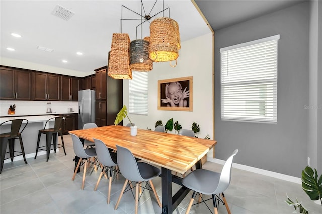 tiled dining space featuring plenty of natural light