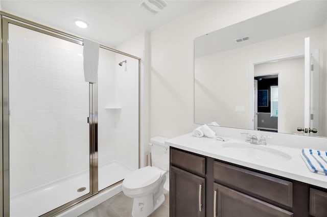 bathroom featuring vanity, a shower with shower door, toilet, and tile patterned floors