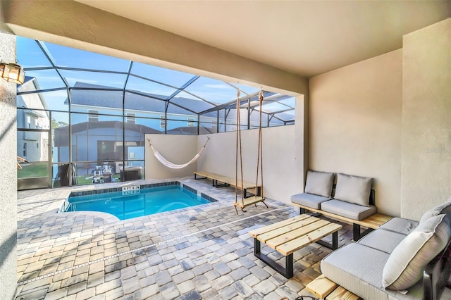 view of swimming pool featuring a patio and a lanai