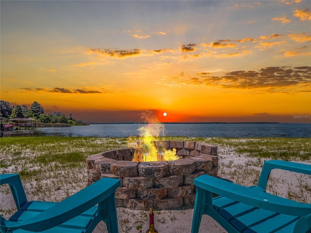 view of patio / terrace featuring a water view and a fire pit