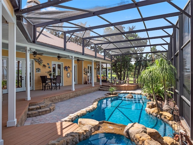 outdoor pool featuring a ceiling fan, a lanai, a patio area, and french doors