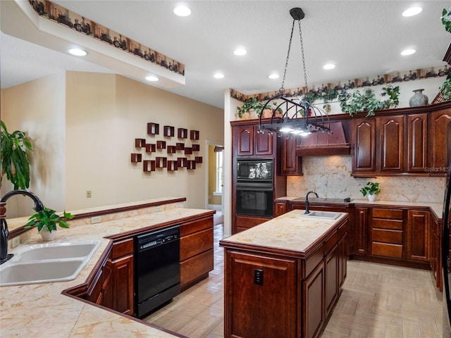 kitchen with a kitchen island with sink, a sink, hanging light fixtures, decorative backsplash, and black appliances